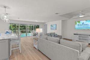 a living room with a couch and a table at Unwind in tropical paradise at Sunflower Cottage in Sanibel
