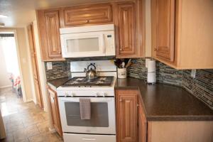 a kitchen with a stove and a microwave at Petroglyph Point Cabin #17 in Moab