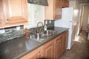 a kitchen with a sink and a refrigerator at Petroglyph Point Cabin #17 in Moab