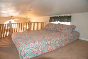 a bedroom with a bed with a colorful blanket at Petroglyph Point Cabin #17 in Moab