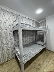 two bunk beds in a room with a wall at Ava Hostel Yerevan in Yerevan