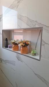 two cakes on a shelf with flowers in them at Suites au sein d'une Villa au centre ville de Rabat in Rabat +65 photos