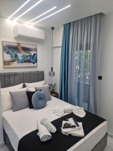 a bedroom with a large bed with blue curtains at Endless Blue Seaview in Paleo Tsifliki
