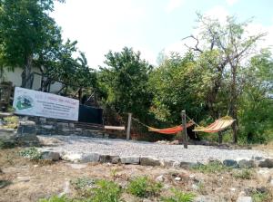 a park with hammocks and a sign in the background at Bed And Breakfasts LA CASETTA in Terranova di Pollino