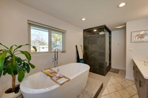 a bathroom with a large white tub and a shower at Less Than 7 Mi to Dtwn Denver Home with Large Yard! in Denver +32 photos