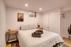 a bedroom with a bed with a white bedspread at Less Than 7 Mi to Dtwn Denver Home with Large Yard! in Denver