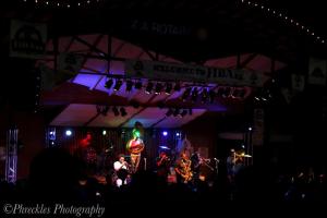 a group of musicians on a stage at night at She Shes Downtown Salidas Sunny Overlook in Salida