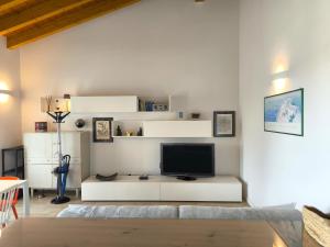 a living room with a tv on a white wall at SG Family - Abbey Home in Sandra