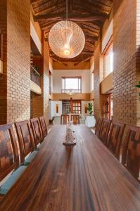 a large wooden table in a room with chairs at Casa Bari Altos de la Antigua in Barichara +39 photos