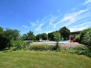 a yard with a swimming pool in a park at Vacation Home in France with Pool in Chaumard