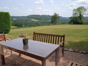 a wooden table with a vase of flowers on it at Vacation Home in France with Pool in Chaumard