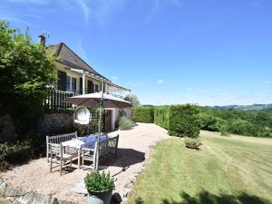 a table and an umbrella in the yard of a house at Vacation Home in France with Pool in Chaumard +28 photos