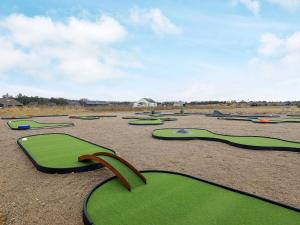 a bunch of green golf courses in a field at Luxury Retreat Tranum Strand - By Traum Ferienwohnungen in Brovst