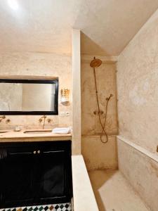 a bathroom with a sink and a shower at Riad Sarasvati & SPA in Marrakesh +36 photos
