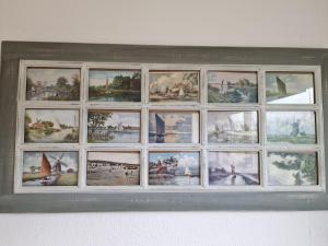 a picture frame of pictures on a wall at 197 Broadside Holiday Chalet near Broads & Beaches in Stalham