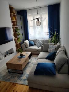 a living room with a couch and a coffee table at Cozy Calming Apartment in Poznań