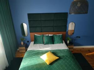 a bedroom with a bed with a yellow pillow on it at Cozy Calming Apartment in Poznań
