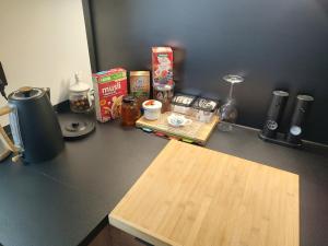 a kitchen counter with a counter top with ingredients on it at Cozy Calming Apartment in Poznań +7 photos