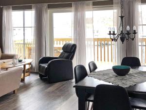 a living room with a dining room table and chairs at 6 person holiday home in Kverva in Dyrvik