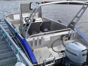 a boat with its door open on the water at 6 person holiday home in Kverva in Dyrvik