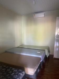 a small room with a bed in the corner at Pousadinha Safira in Sinop +3 photos