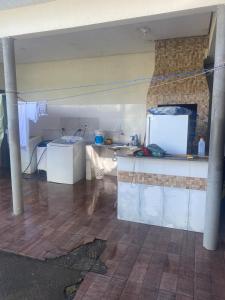 a kitchen with a sink and a counter in a room at Pousadinha Safira in Sinop