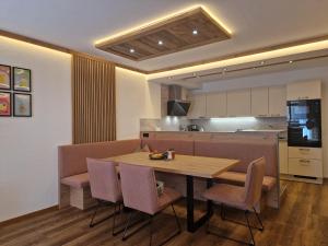 a kitchen and dining room with a wooden table and chairs at Apartment Lamtana in Ischgl