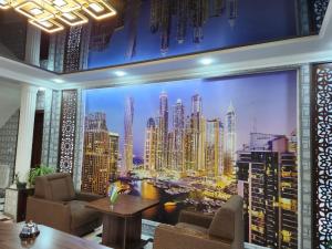 a room with a large mural of a city at Sadaf Hotel in Guliston