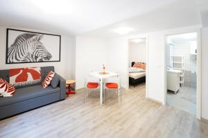a living room with a couch and a table at The LOFT Apartments Ljubljana in Ljubljana