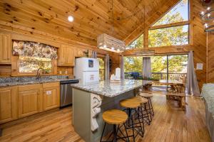 a kitchen with wooden walls and a wooden floor at Absolutely Fabulous by American Patriot Getaways in Park Settlement