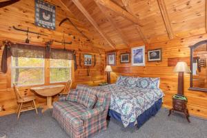 a bedroom with a bed and a couch and a chair at All Shook Up by American Patriot Getaways in Cove Creek Cascades
