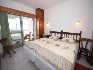 a bedroom with a large bed and a window at Holiday Home Mesa del Mar near Black Beach in Tacoronte
