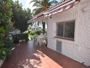a patio with tables and chairs on a house at Holiday Home Mesa del Mar near Black Beach in Tacoronte