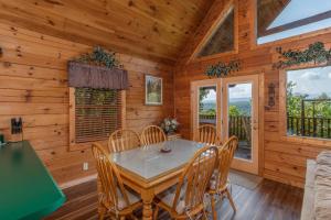 a dining room with a table and chairs in a cabin at Angels Majestic View in Williamsburg