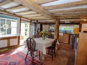 a kitchen with a table with a vase of flowers on it at Bank House in Norwich