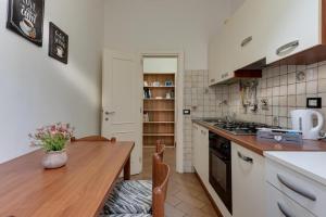 a kitchen with a wooden table and a counter top at Apartment for 2 Florence Redi in Florence