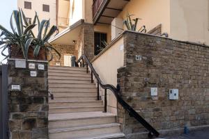a set of stairs in a building with a potted plant at Apartment for 2 Florence Redi in Florence +3 photos