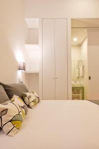 a bedroom with a bed and a dresser at MyStay Porto Bolhão in Porto