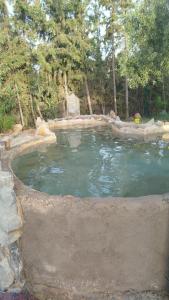 a large pool of water in a yard at Maison, situé dans une ferme in Boualaïne Tahata