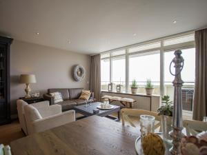 a living room with a couch and a table at Apartment in Noordwijk near Beach in Noordwijk +32 photos