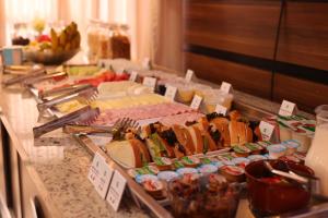 a buffet with many different types of food on a table at Hotel Golden Park Uberlandia By Nacional Inn in Uberlândia