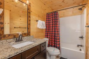a bathroom with a sink and a toilet at Bessy Bears Cabin by American Patriot Getaways in Glade +18 photos
