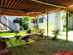 an outdoor patio with chairs and a table at Taganga blue in Taganga