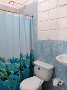 a bathroom with a white toilet and a sink at Taganga blue in Taganga