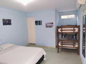 a bedroom with a bed and a chair in it at Taganga blue in Taganga +23 photos