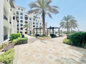 un patio con palmeras frente a un edificio en Sophisticated Yas Island Escape, en Abu Dabi