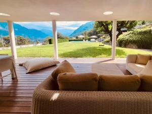 a living room with a couch on a wooden deck at Villa Panoramica in Artogne