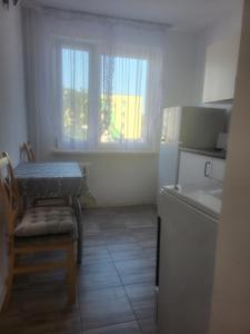 a kitchen with a table and a chair and a window at Panorama in Dzierżoniów