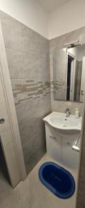 a bathroom with a sink and a mirror at Short Location Paratore Casa Melina in Catania