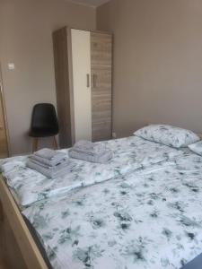 a bedroom with a large bed with a floral bedspread at Panorama in Dzierżoniów